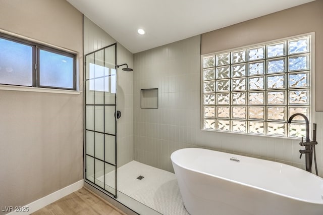 bathroom with sink, independent shower and bath, and hardwood / wood-style floors