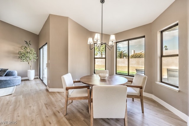 dining area featuring light hardwood / wood-style flooring and a chandelier