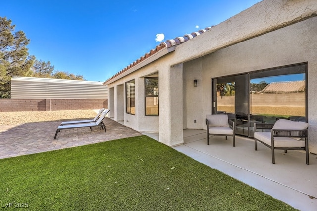 rear view of house featuring a yard and a patio