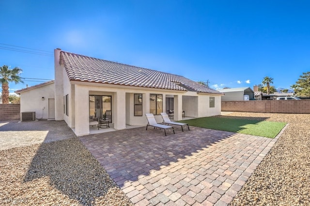 rear view of property with central AC unit and a patio area