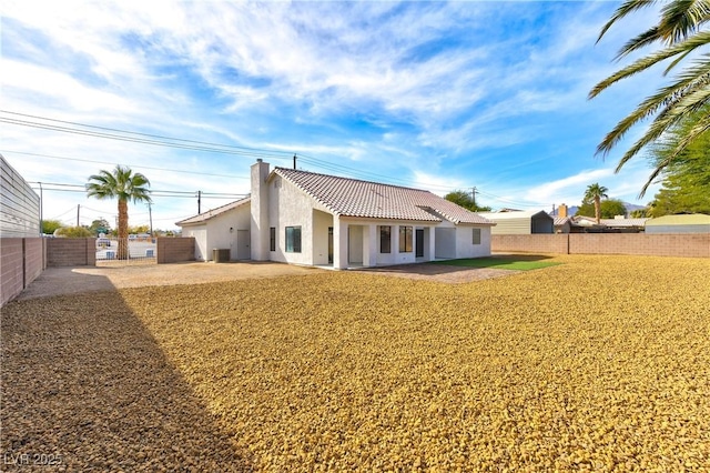 back of house with a patio area and a lawn