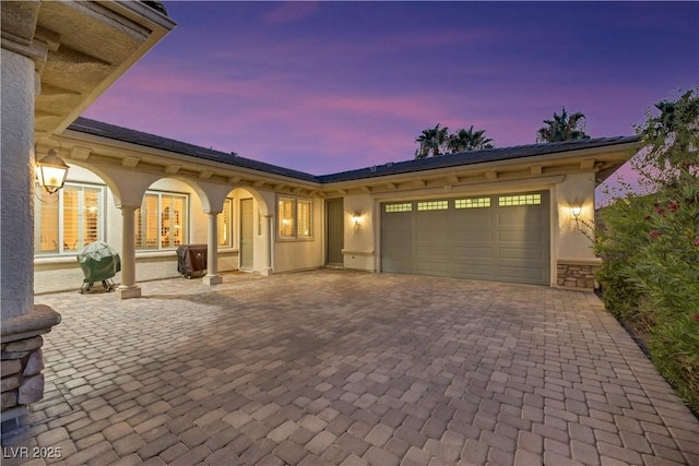 mediterranean / spanish home featuring a garage