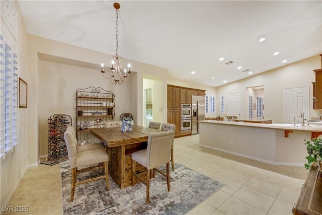 tiled dining area featuring lofted ceiling, a notable chandelier, and sink