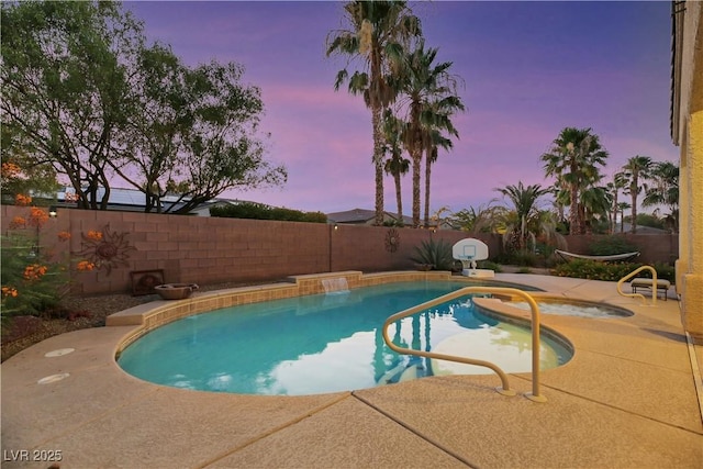 pool at dusk featuring a patio