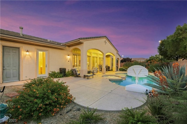 exterior space with a pool with hot tub and a patio