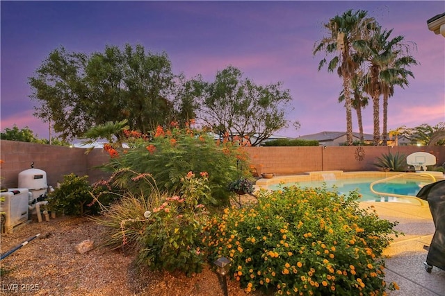 view of pool at dusk