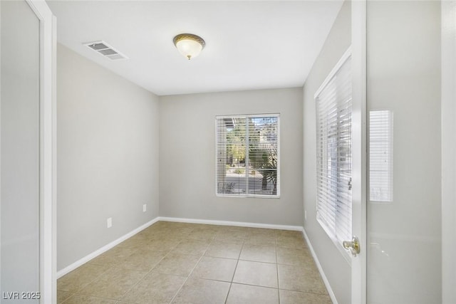 empty room with light tile patterned floors