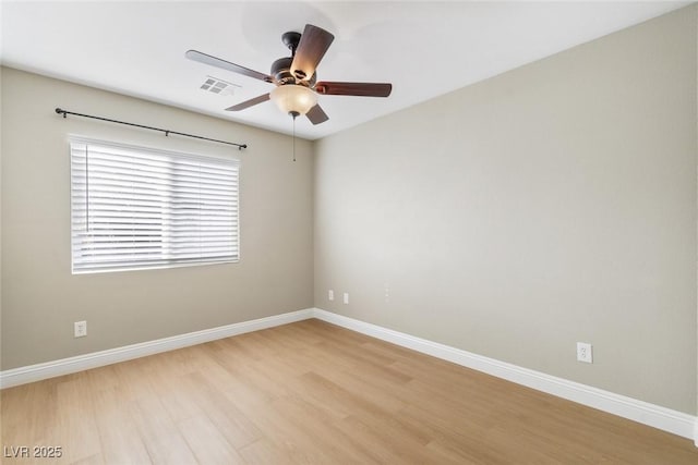 spare room featuring ceiling fan and light wood-type flooring