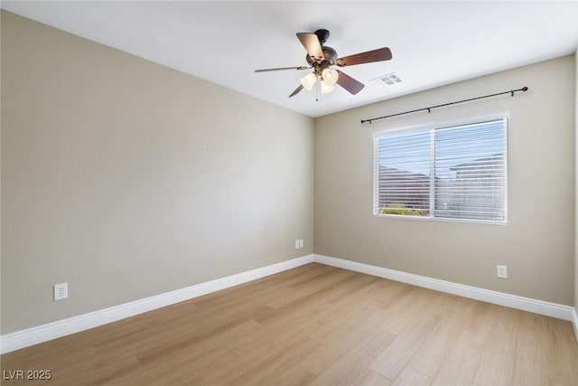 spare room featuring light hardwood / wood-style floors and ceiling fan