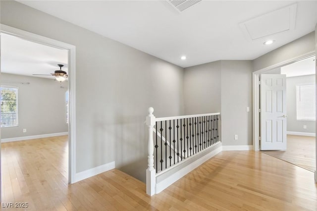 corridor with light hardwood / wood-style floors