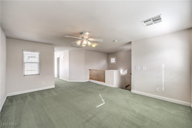 carpeted empty room with ceiling fan