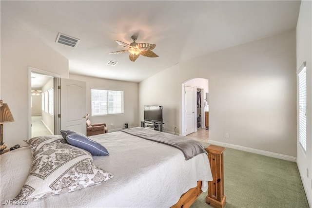 bedroom with ensuite bathroom, lofted ceiling, light colored carpet, and ceiling fan