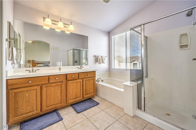 bathroom with tile patterned flooring, vanity, lofted ceiling, and separate shower and tub