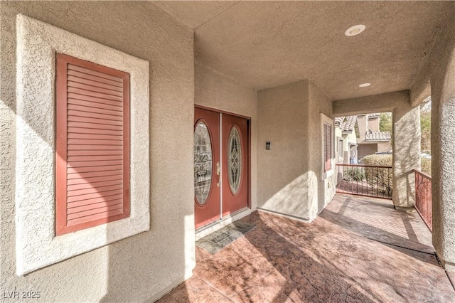 doorway to property featuring covered porch