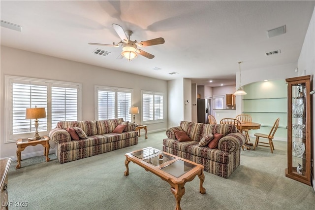 living room featuring light colored carpet and ceiling fan