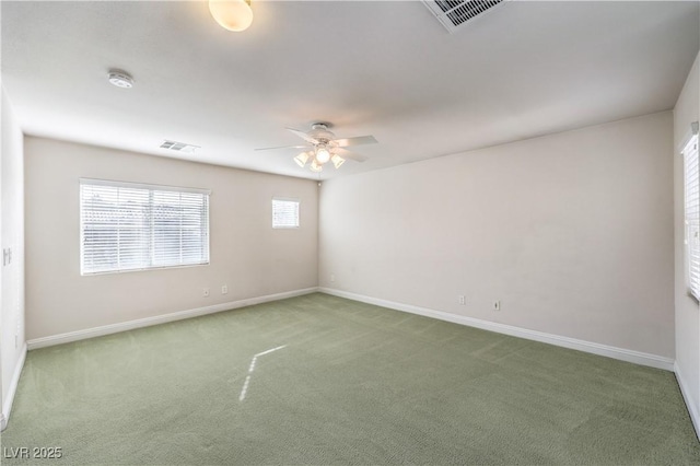 carpeted spare room with ceiling fan