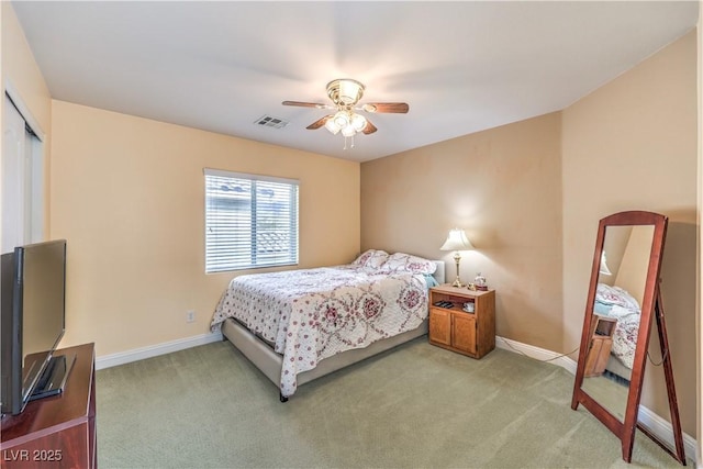 carpeted bedroom featuring ceiling fan and a closet