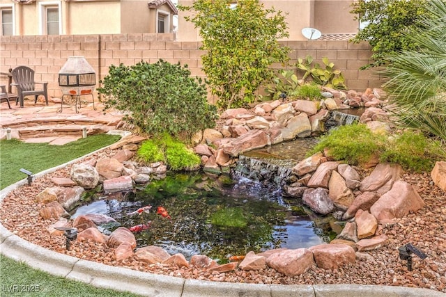 view of yard with a garden pond