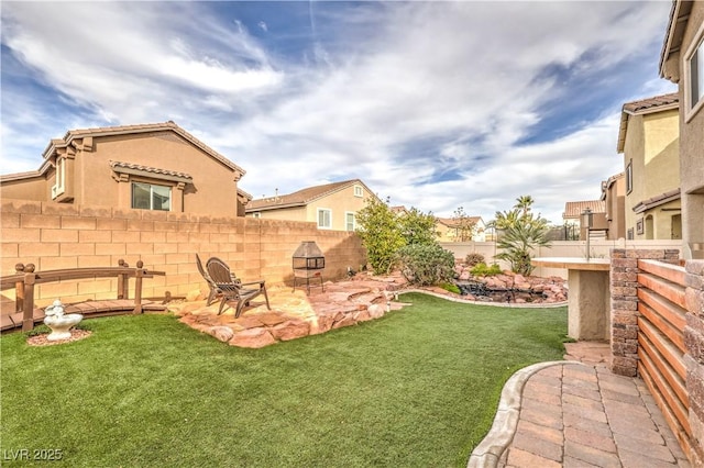 view of yard featuring a fire pit and a patio area