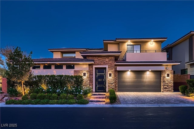 view of front facade featuring a garage and a balcony