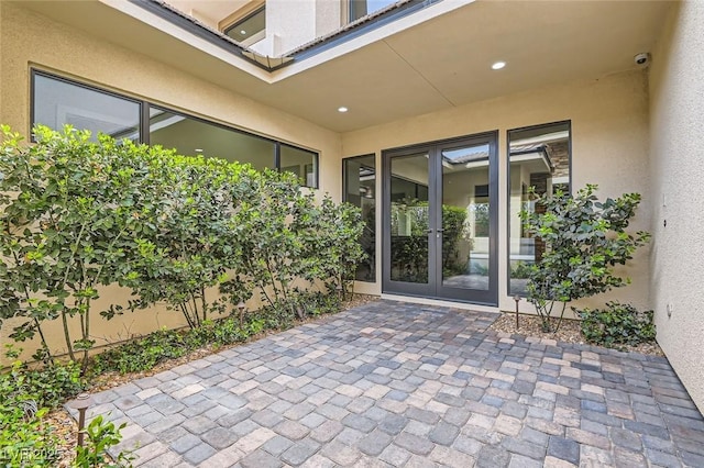 view of exterior entry featuring a patio area and french doors