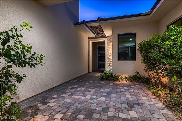 property entrance featuring a patio