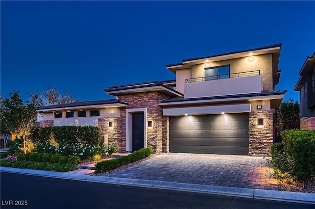 view of front of home featuring a balcony and a garage