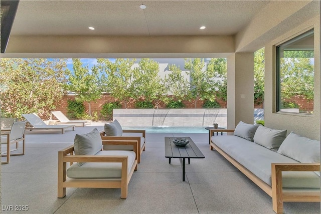 view of patio / terrace featuring outdoor lounge area and pool water feature