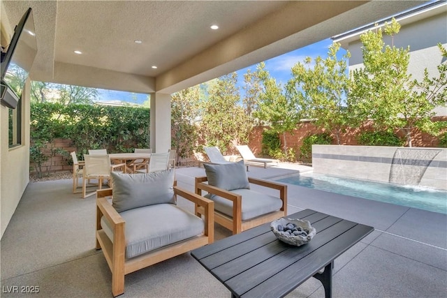 view of patio with a fenced in pool and pool water feature