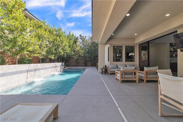 view of swimming pool featuring a patio, an outdoor hangout area, and pool water feature