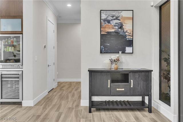 hallway with ornamental molding and wine cooler