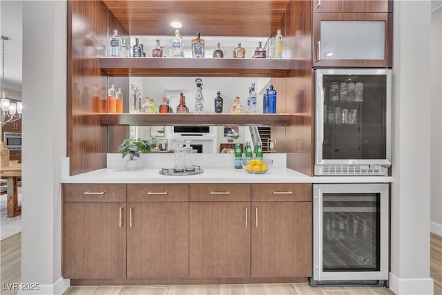 bar featuring wine cooler and stainless steel microwave