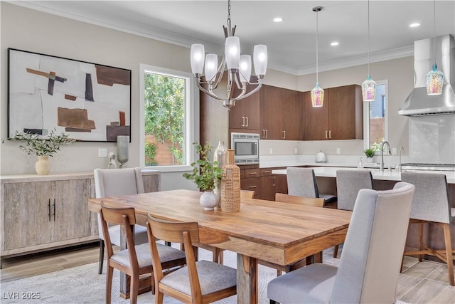 dining area featuring ornamental molding and a chandelier