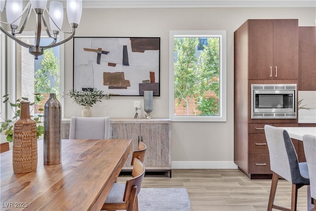 dining room featuring light hardwood / wood-style flooring and a chandelier