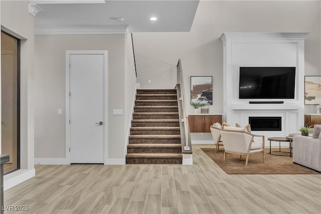 interior space with ornamental molding and light hardwood / wood-style floors