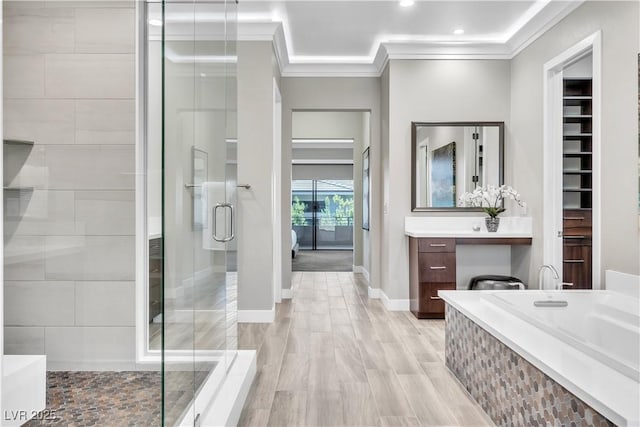 bathroom with ornamental molding, separate shower and tub, and vanity