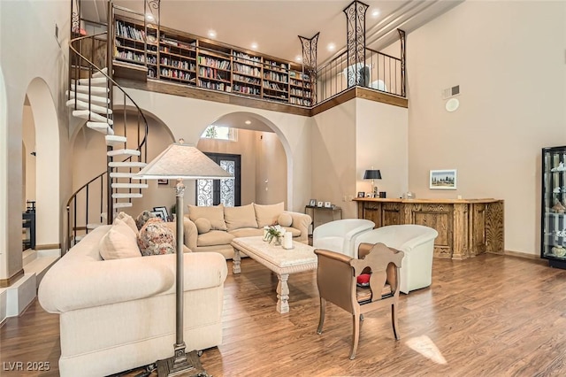 living room with a high ceiling and hardwood / wood-style floors