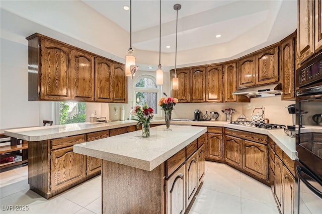 kitchen featuring hanging light fixtures, a center island, light tile patterned floors, gas cooktop, and kitchen peninsula