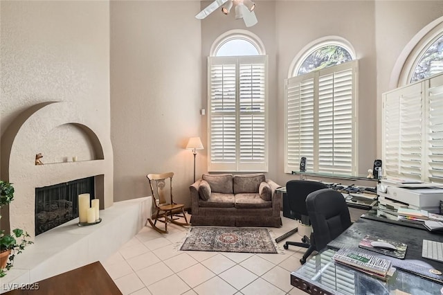 office area with light tile patterned floors and ceiling fan