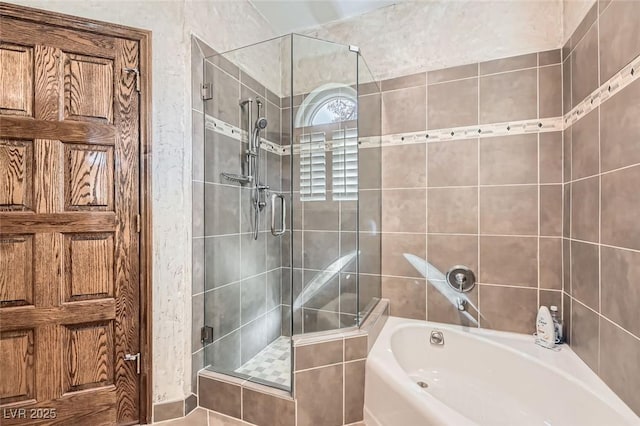 bathroom featuring separate shower and tub