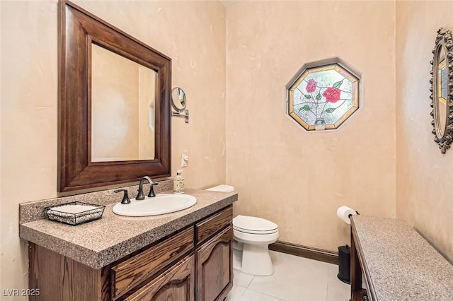 bathroom with vanity, tile patterned floors, and toilet