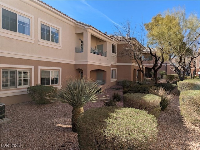 10524 Pine Gardens Ct Unit 203, Las Vegas, NV 89144 - rear view of property with stucco siding, a tiled roof, and cooling unit