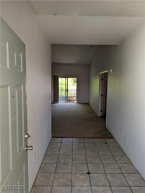 10524 Pine Gardens Ct Unit 203, Las Vegas, NV 89144 - corridor with light colored carpet, light tile patterned floors, and lofted ceiling