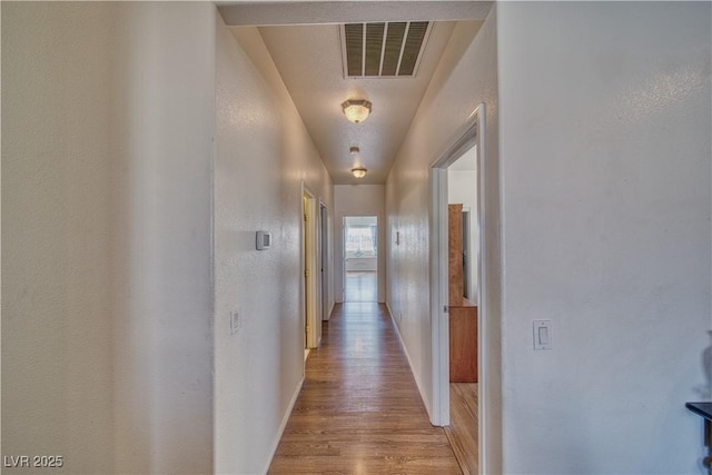 corridor with light wood-type flooring