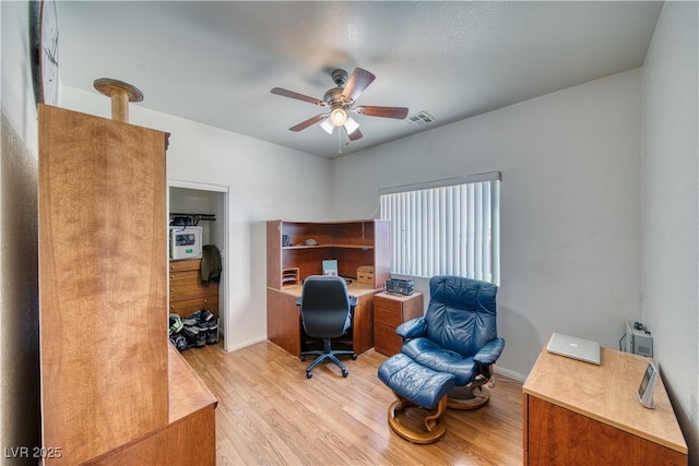 office featuring light hardwood / wood-style floors and ceiling fan