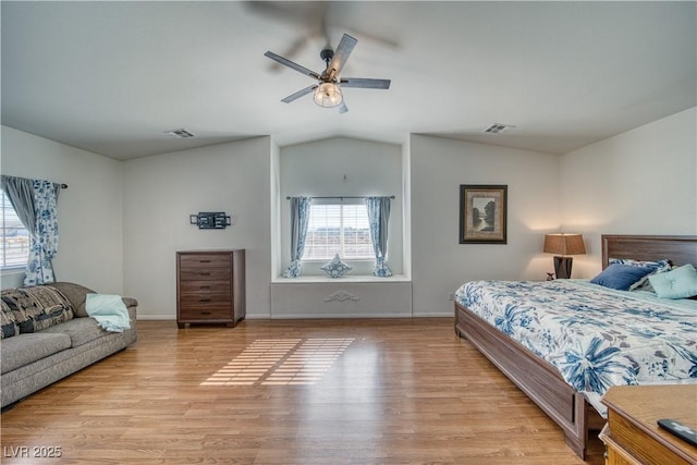 bedroom featuring ceiling fan, lofted ceiling, and light wood-type flooring