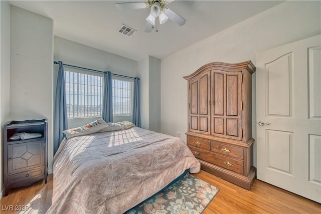 bedroom with ceiling fan and light wood-type flooring