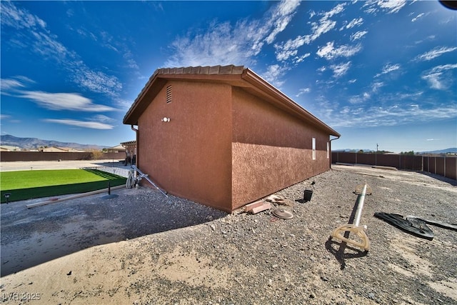 view of property exterior with a mountain view