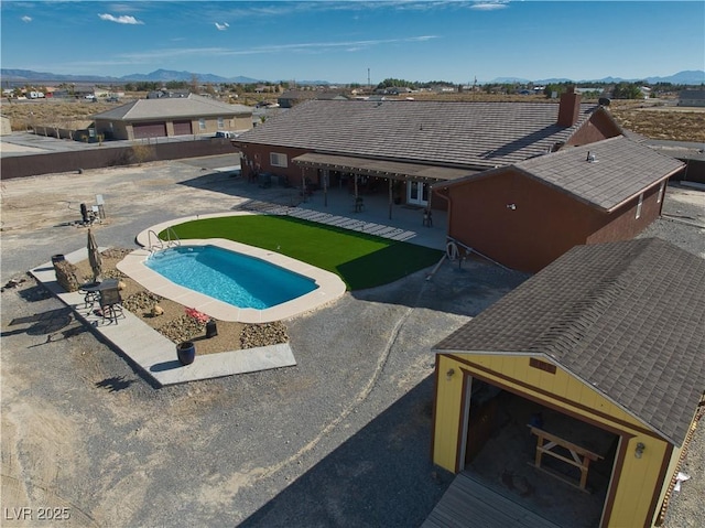 view of swimming pool featuring a patio and a mountain view