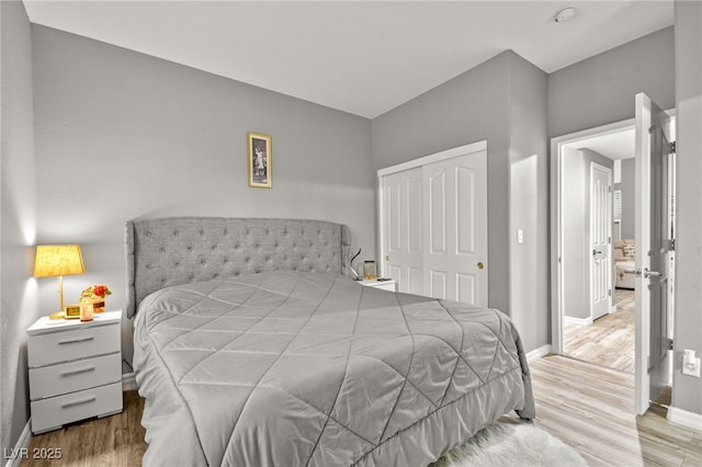 bedroom featuring light hardwood / wood-style floors and a closet